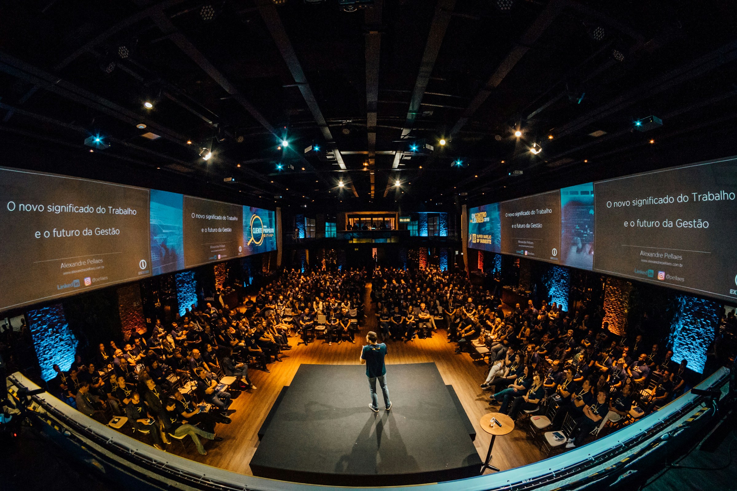 Conference stage, speaker and attendees